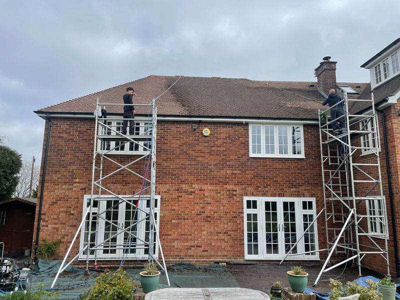 Roof cleaning carried out safely from scaffold towers by The Roof Moss Cleaners in Banstead
